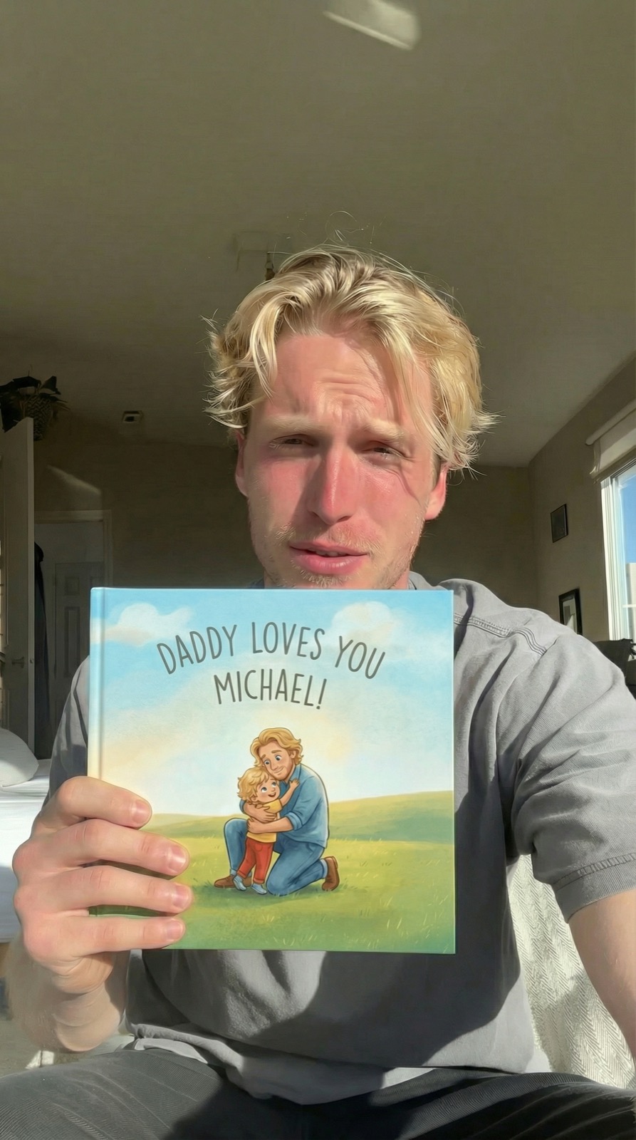 Dad wiping joyful tears with book